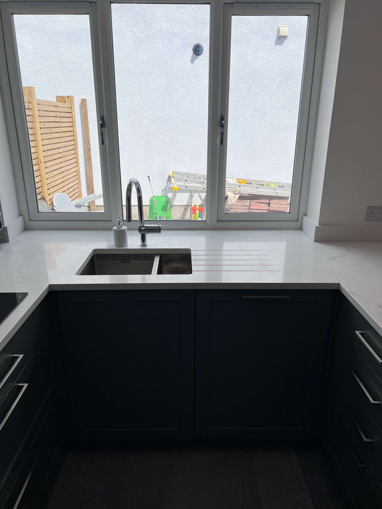 dark-green-kitchen-withwhite-marble-coutnertop-sink